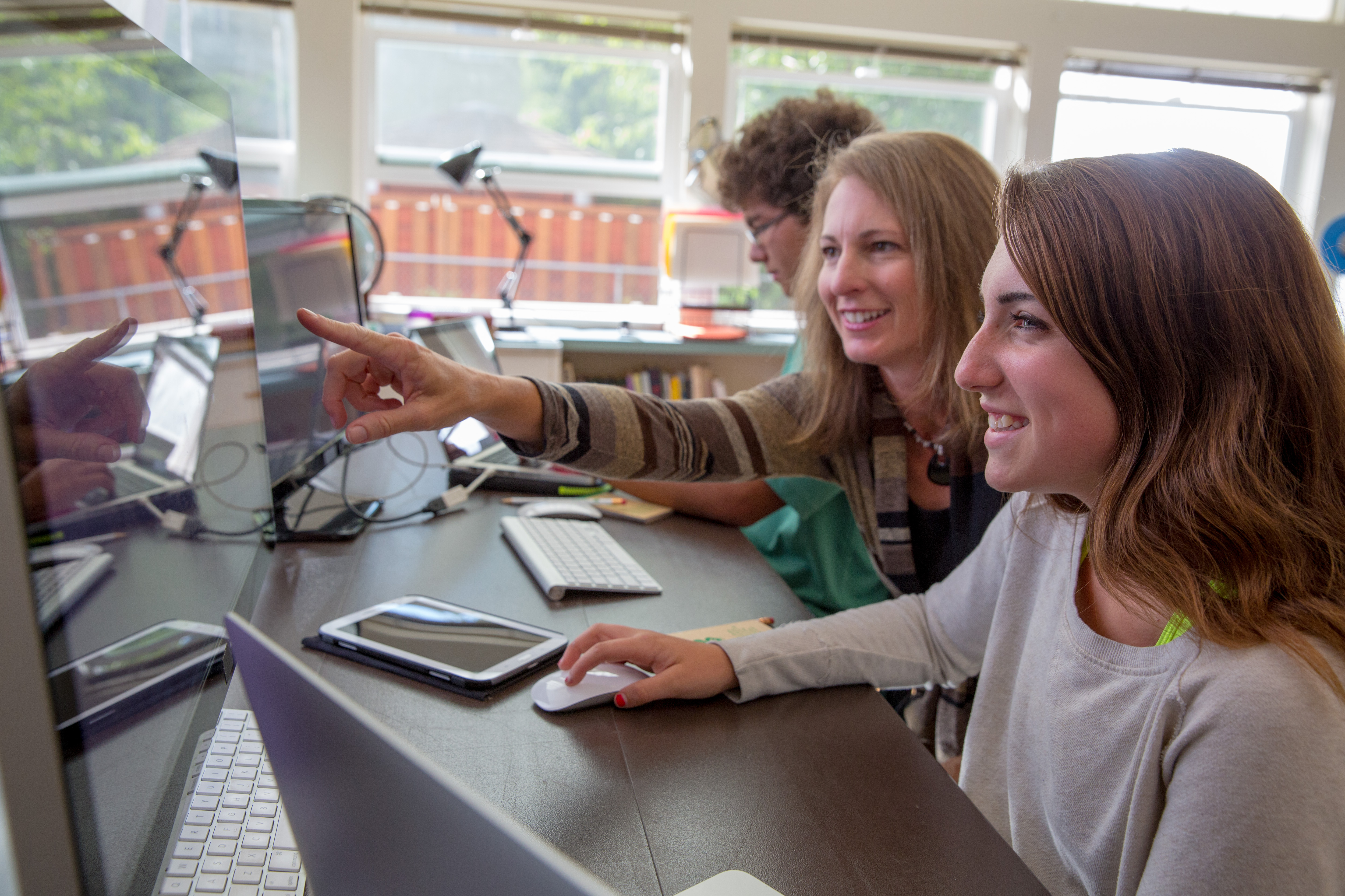 Young woman and adult at computer